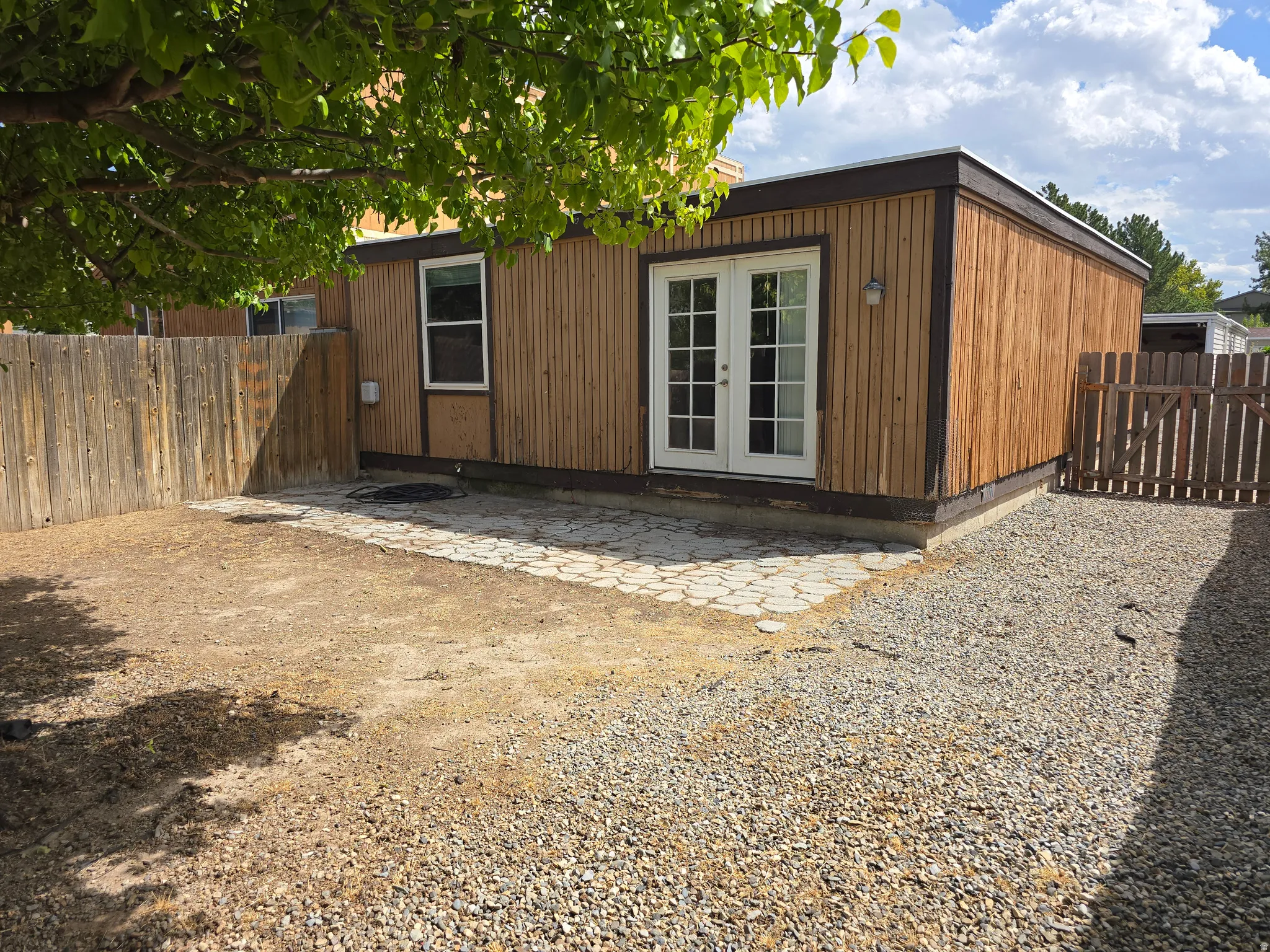 Wood-sided exterior with white-framed double French doors