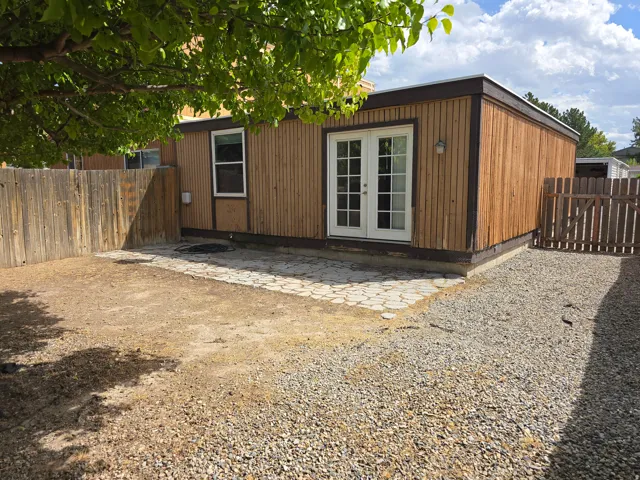 Wood-sided exterior with white-framed double French doors