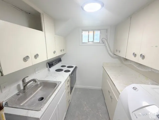 Kitchen featuring solid-surface countertops, integrated stainless steel sink with high-arc faucet, white cabinetry, electric range, and flush-mount ceiling lighting