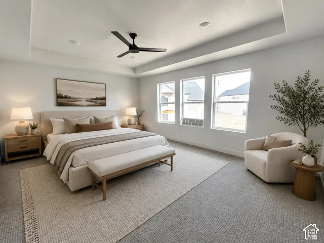 Tray ceiling with a modern black ceiling fan, recessed lighting, and three large windows