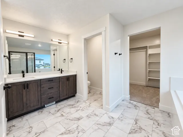 Dual vanity with dark wood-finish cabinetry and white countertops