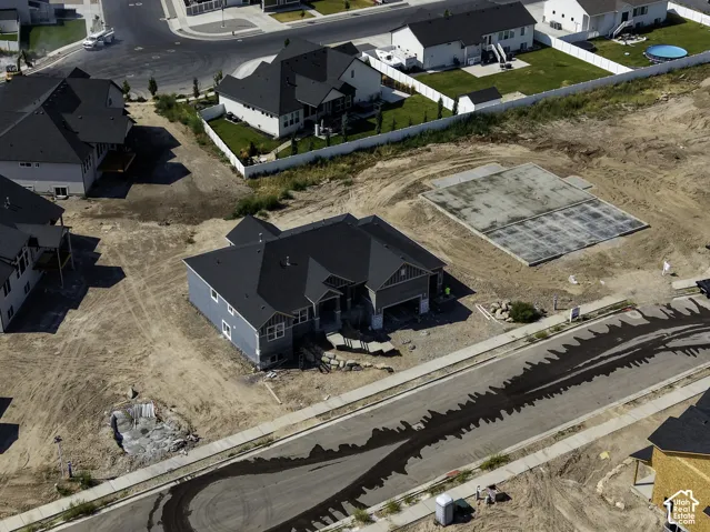 Newly constructed residence with a dark shingle roof and light blue siding