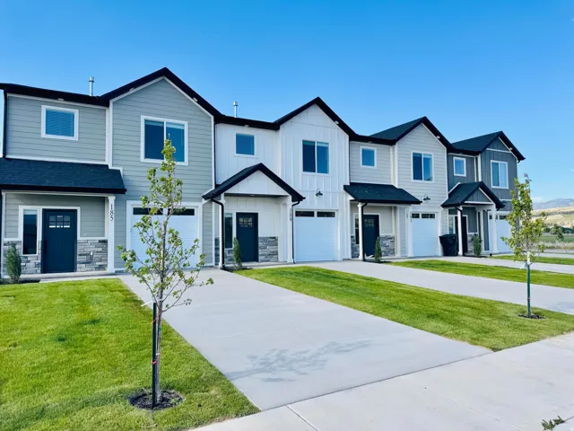 Modern townhome exteriors featuring varied siding, stone accents, and attached garages
