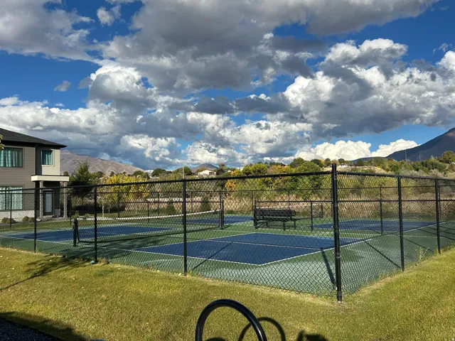 Two fenced pickleball courts with a synthetic surface