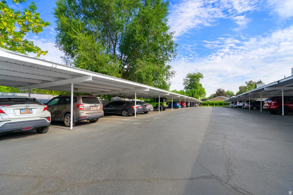 Extensive carport parking structure with multiple covered spaces and a paved surface