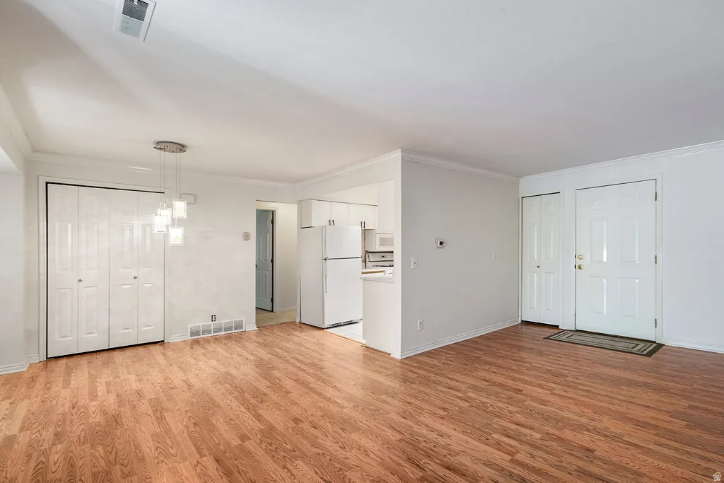 Wood-finish flooring, white walls, double bi-fold closet doors, and recessed lighting