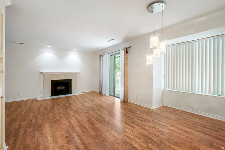 Hardwood-finish flooring, recessed lighting, and crown molding