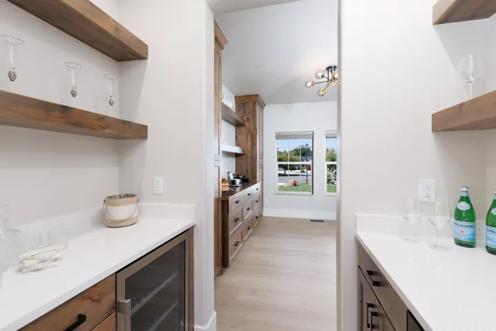 Hallway with wood-finish flooring, recessed lighting, and a modern chandelier