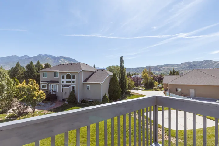 Contemporary residence with a multi-level rear exterior, extensive window array, and a ground-level patio area