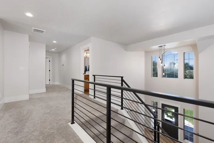 Carpeted hallway with recessed lighting