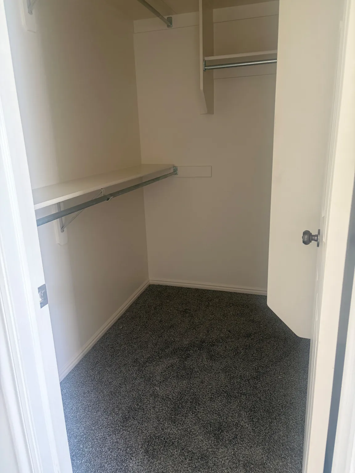 Walk-in closet with integrated shelving and hanging rods