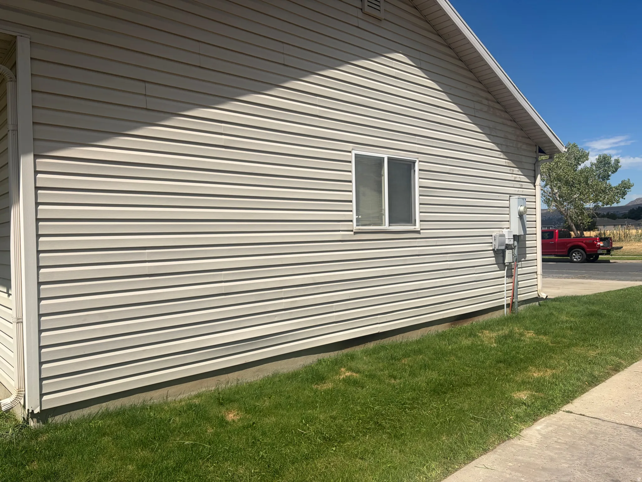 Vinyl siding exterior with a single window