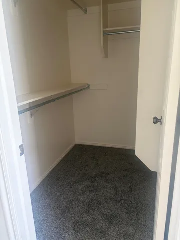 Walk-in closet with integrated shelving and hanging rods