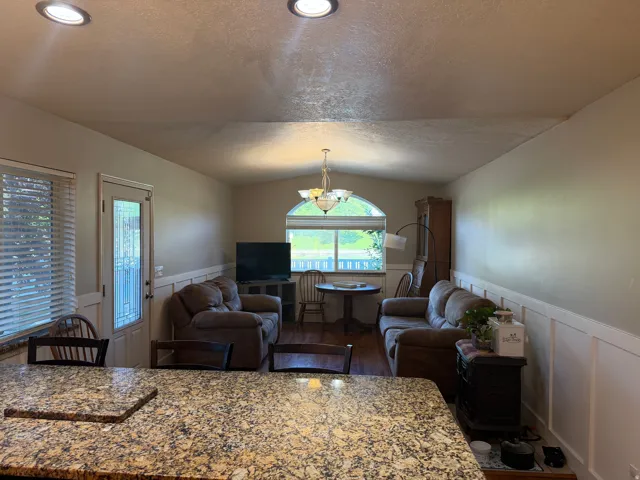 Family room off kitchen area with hardwood-finish flooring