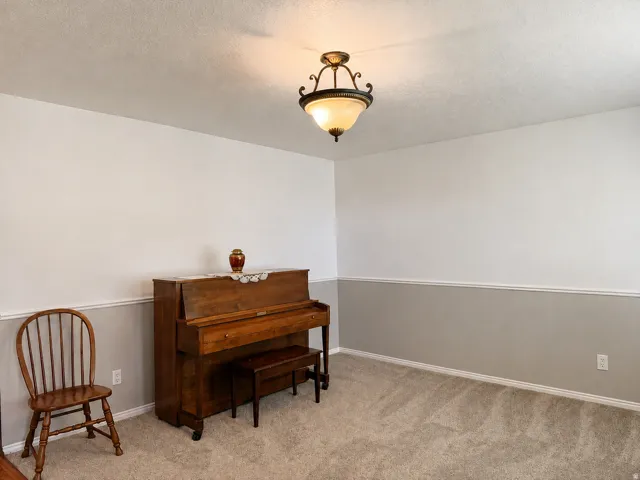 Recessed ceiling lighting, crown molding, and two-tone wall paint create a defined aesthetic