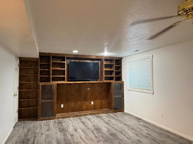 Built-in wood-finish cabinetry and shelving, recessed lighting, in downstairs family room