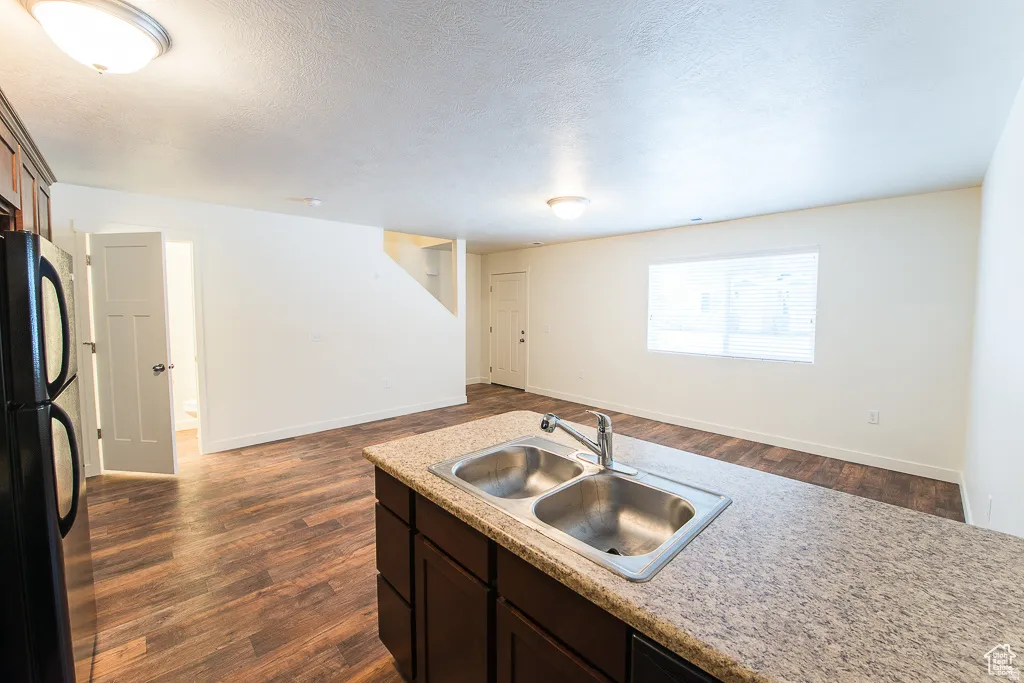 Kitchen island with a double basin stainless steel sink and granite-style countertop