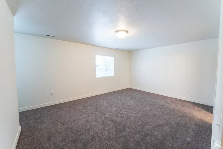 Recessed window, ceiling-mounted light fixture, and dark gray carpeting