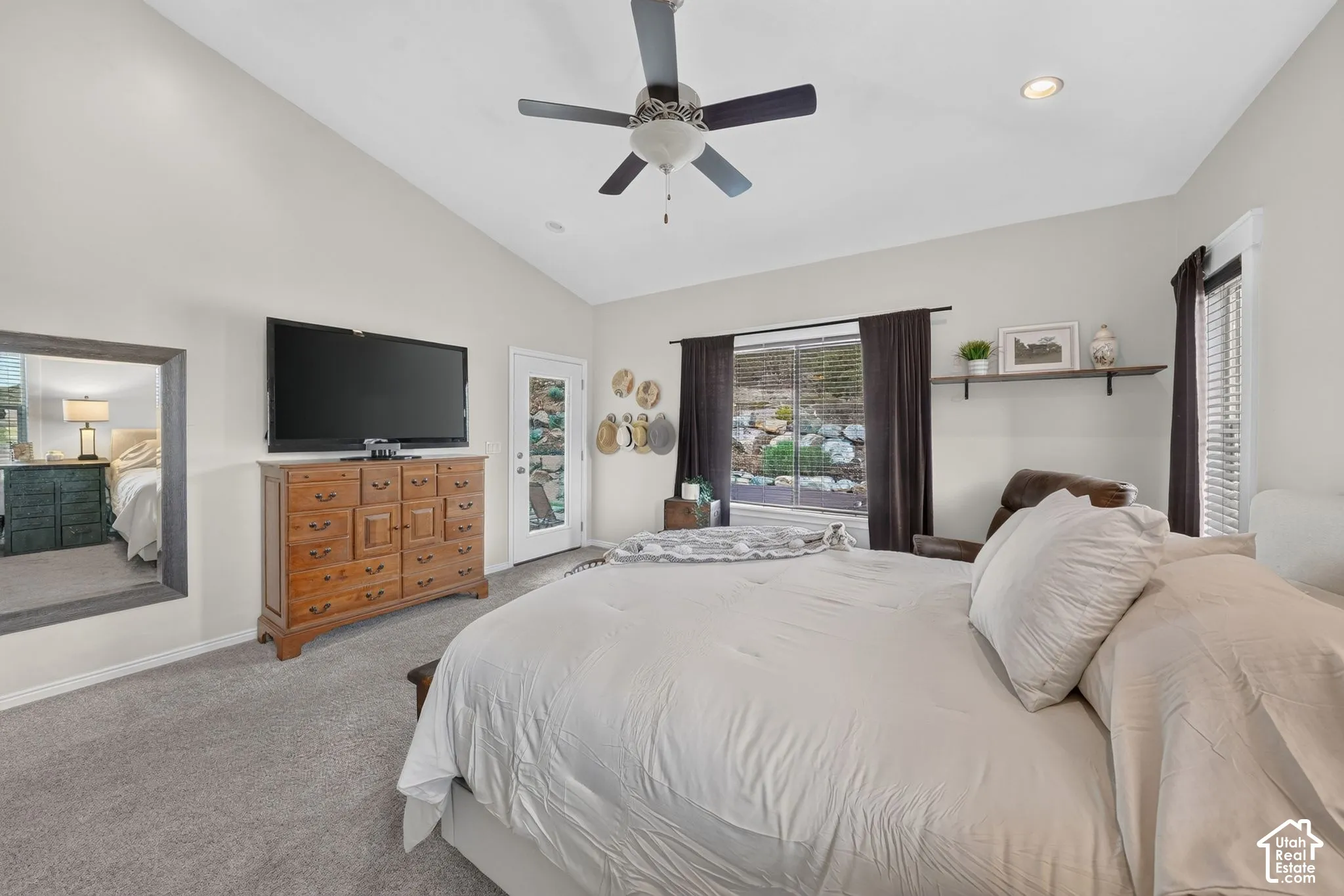 Vaulted ceiling with a ceiling fan, recessed lighting, and soft gray carpet