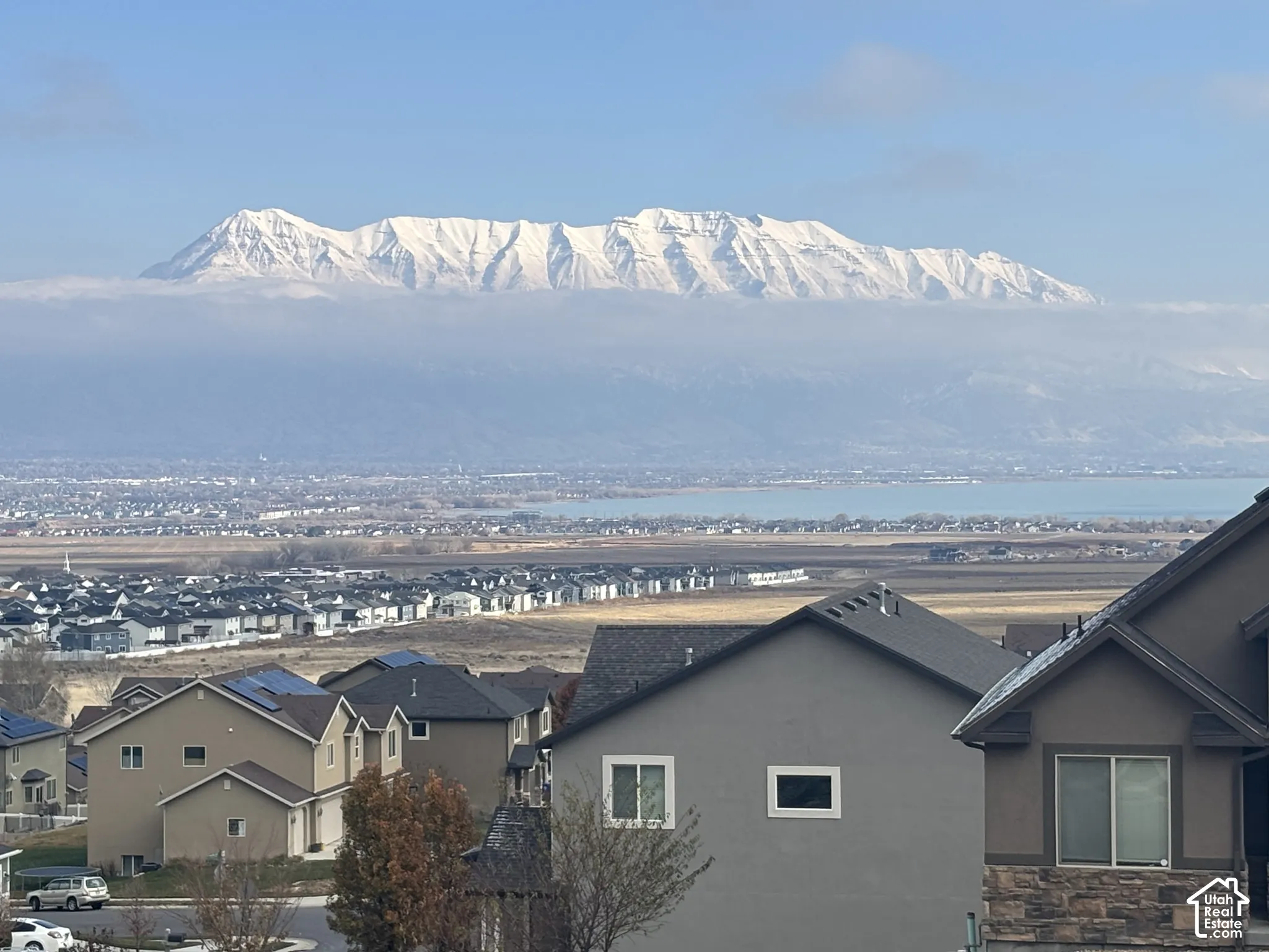 View from the front porch.  Expansive mountain range backdrop and distant water body