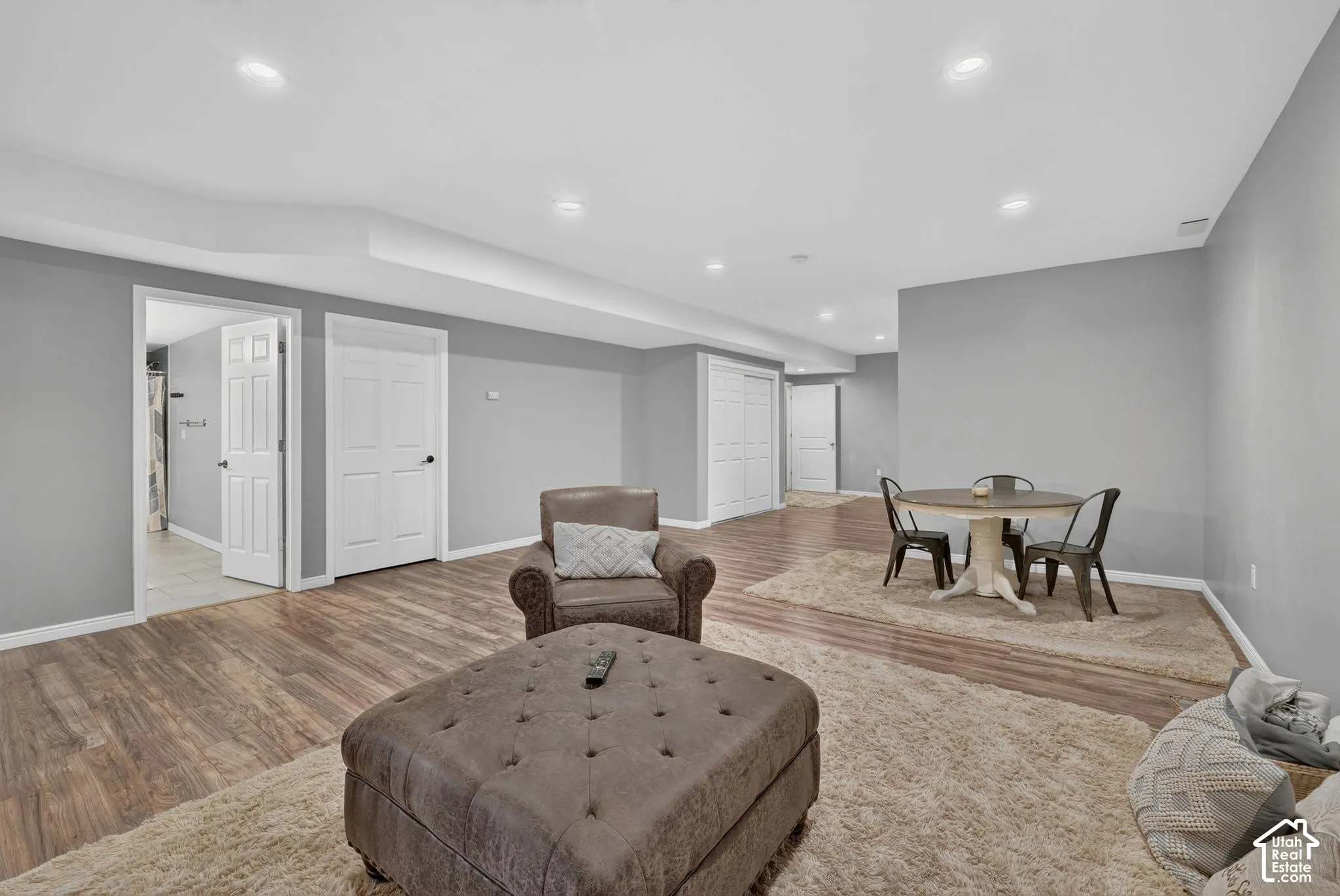 Expansive finished area featuring wood-finish flooring and recessed lighting