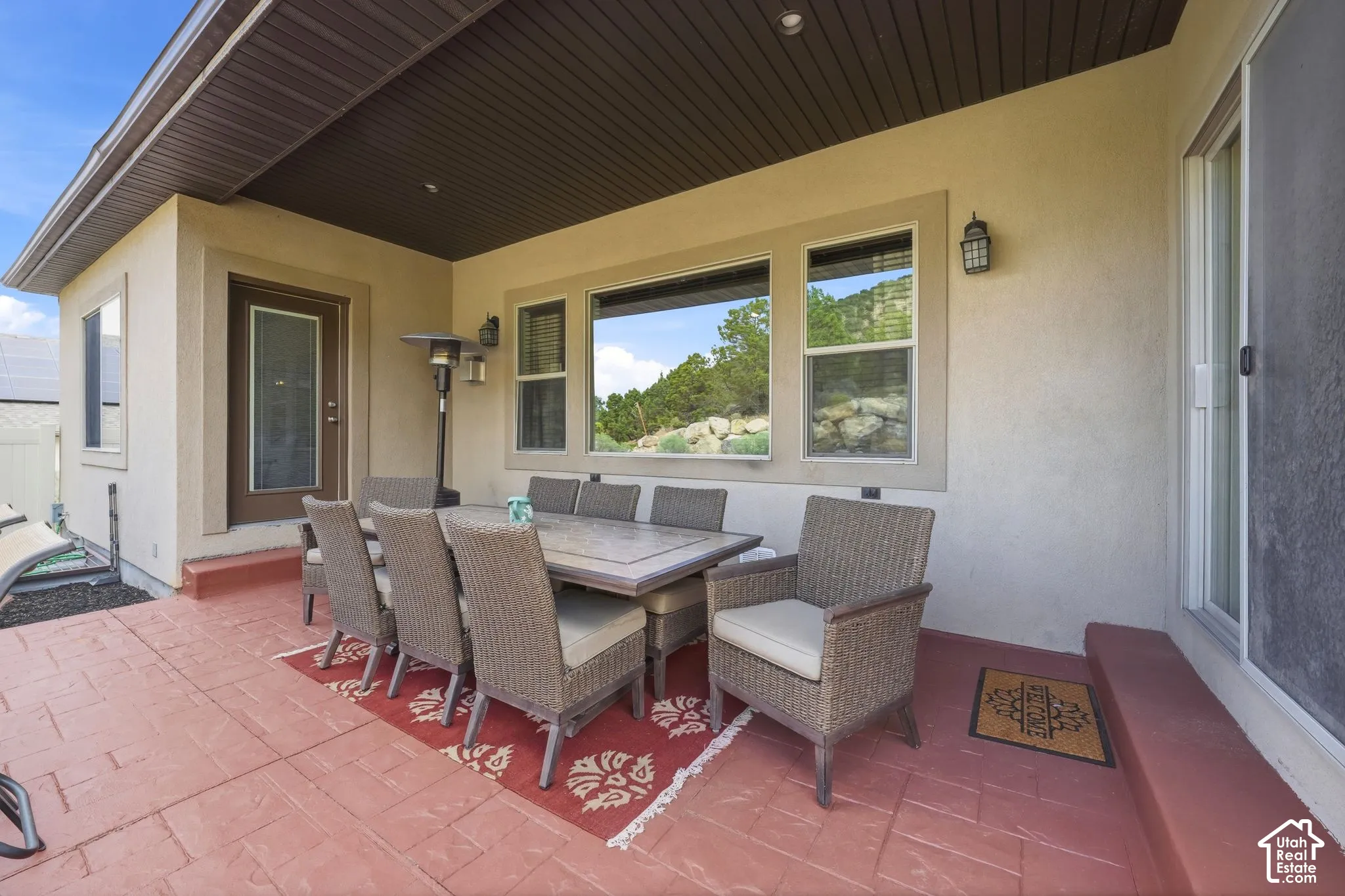 Covered patio featuring a stamped concrete surface and an exterior door