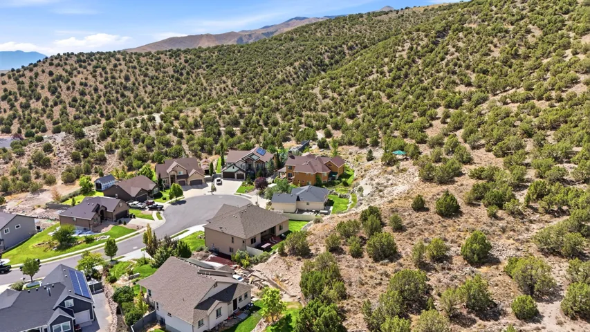 Residential neighborhood at the base of a brush-covered hillside