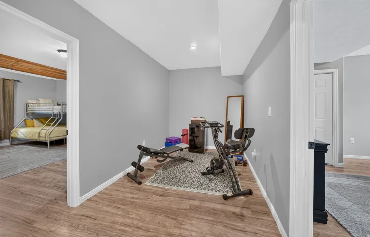 Wood-finish flooring with light gray wall paint and white trim