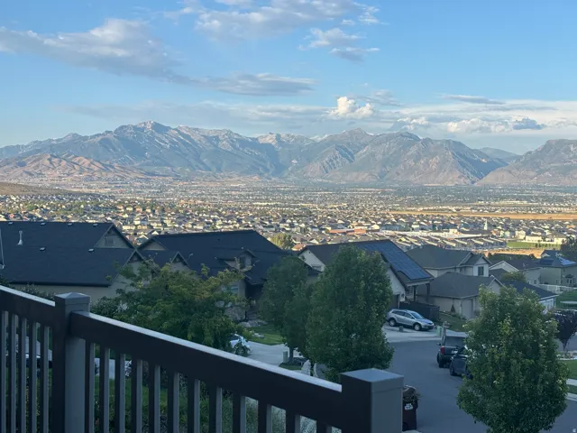 Expansive mountain range backdrop and distant city panorama