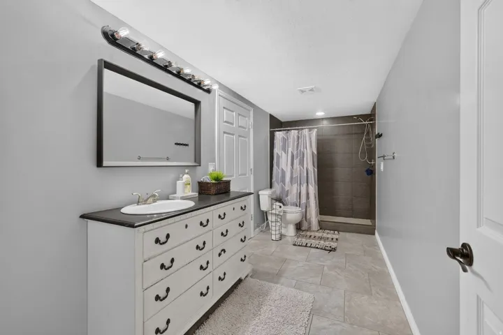 Vanity with integrated sink, rectangular mirror, and bar lighting