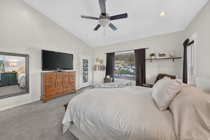 Vaulted ceiling with a ceiling fan, recessed lighting, and soft gray carpet
