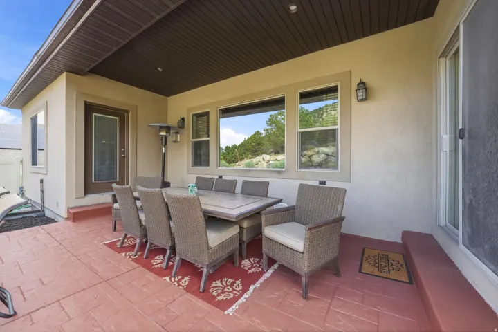 Covered patio featuring a stamped concrete surface and an exterior door