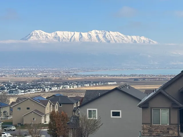 View from the front porch.  Expansive mountain range backdrop and distant water body