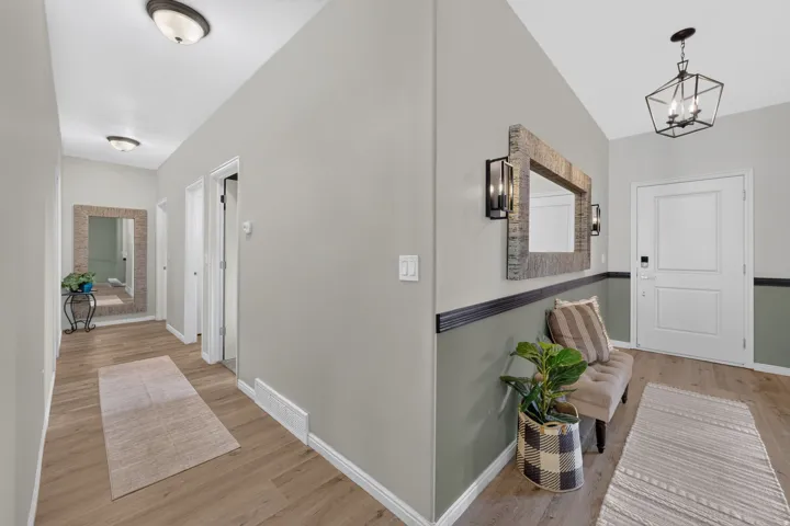 Hardwood-finish flooring, recessed lighting, ceiling-mounted light fixture, and paneled interior doors