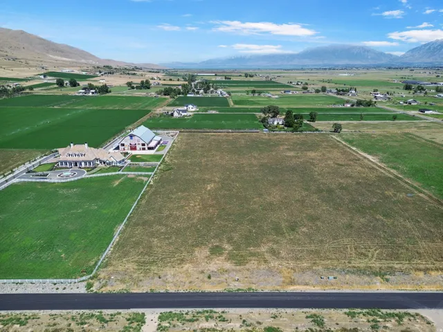 Expansive land parcel featuring open fields and distant mountain ranges
