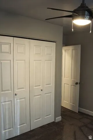 Bifold panel doors, overhead ceiling fan with integrated lighting, and neutral wall paint