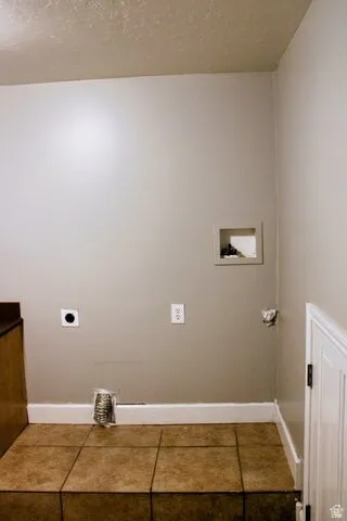 Tile flooring, wall-mounted electrical outlets, and access panel