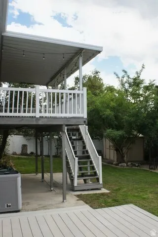 Covered upper-level balcony with white railing