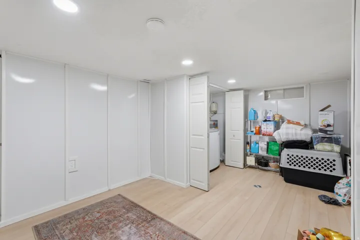 [Unit 1] Dedicated laundry space featuring side-by-side full-size washer and dryer hookups with clean, closed-door storage and easy water heater access.