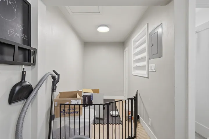 [Unit 2] Clean interior dining or utility nook with tiled flooring, neutral walls, flush lighting, and easy access to electrical panel and storage space.