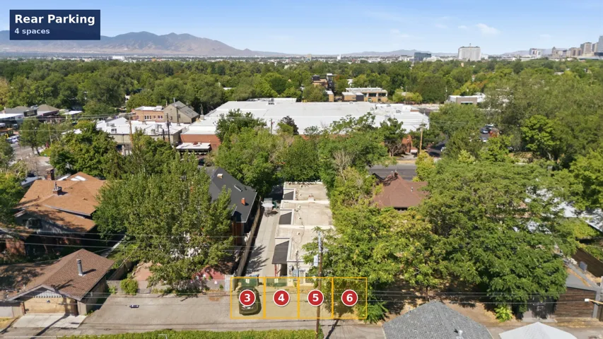 Aerial layout map showing 4 dedicated off-street rear parking stalls accessed via alleyway, providing tenant parking.