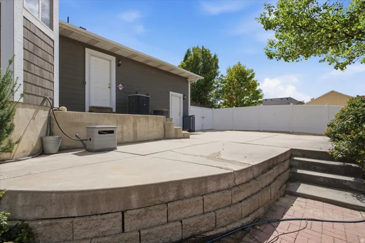 Expansive concrete patio with block retaining wall and integrated stairs