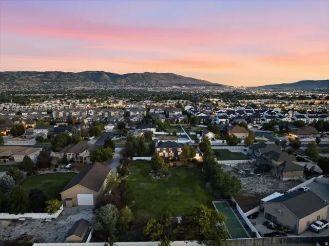 Expansive lot with green space, an additional detached building, and a paved court