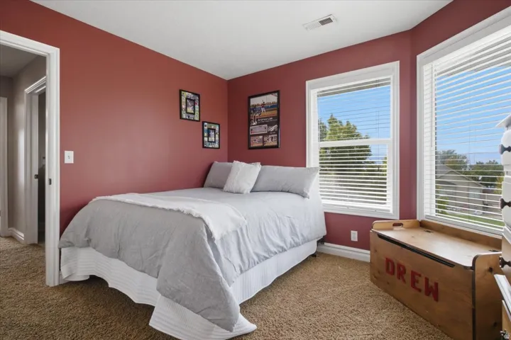 carpeting with multiple windows and a white trim