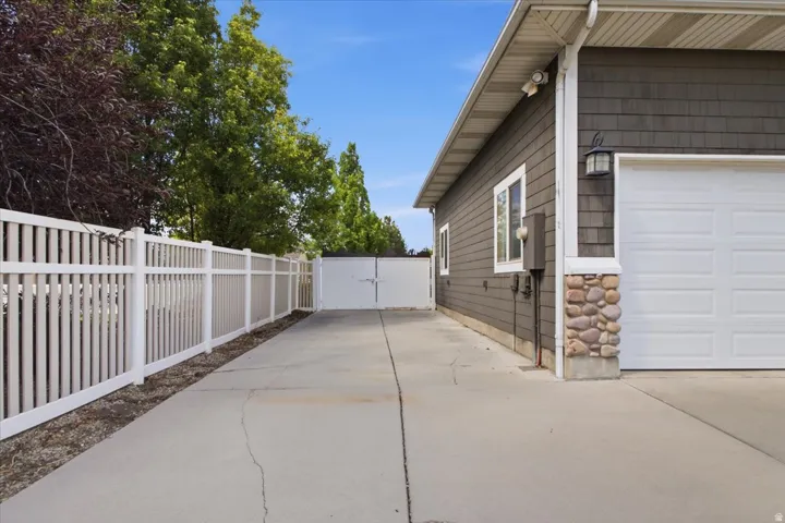 Concrete driveway with white vinyl fencing