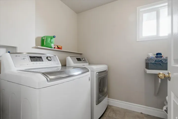 Utility room with tiled flooring and a built-in window
