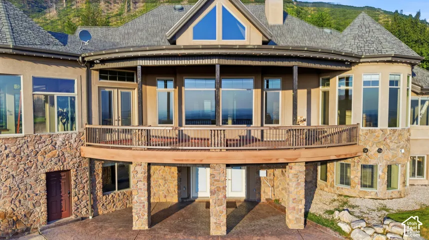 Stone veneer and stucco exterior with multiple large windows