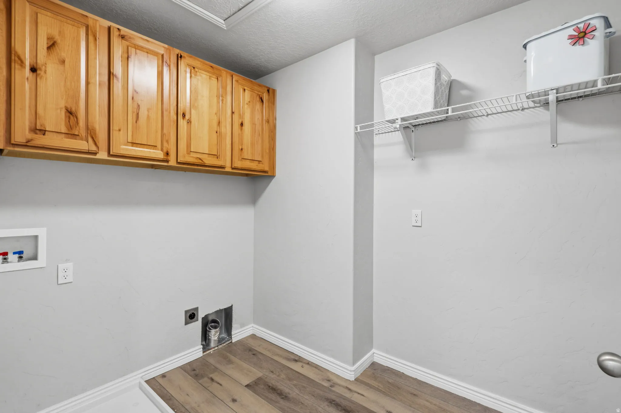 Wood-finish flooring with white baseboards