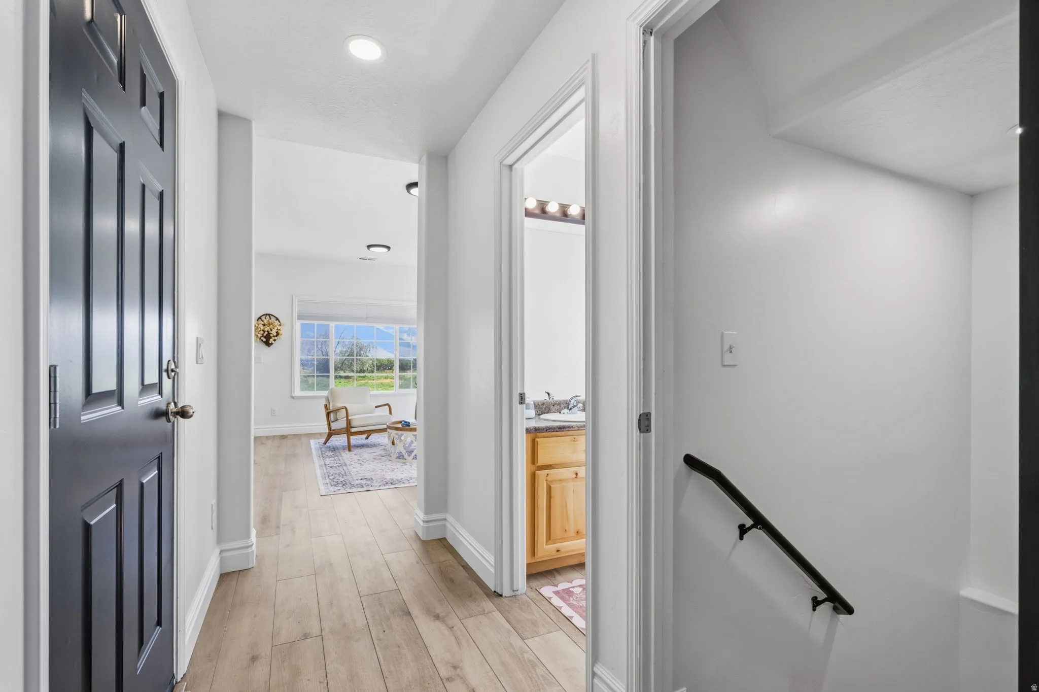 Wood-finish flooring throughout the hallway