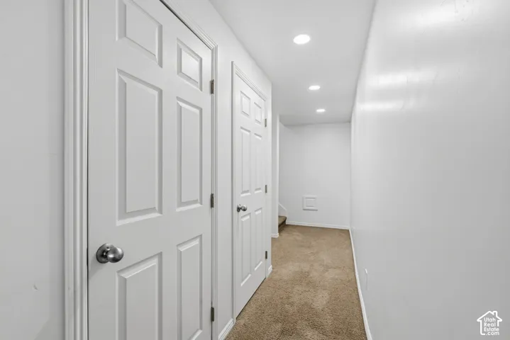 Recessed ceiling lighting, paneled doors, and neutral carpeting